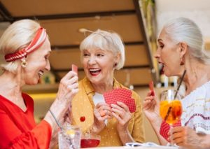 cheerful sisters playing cards