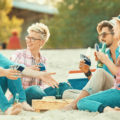 Group of Friends Playing cards at the beach