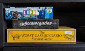 3 boxed board games stored horizontally