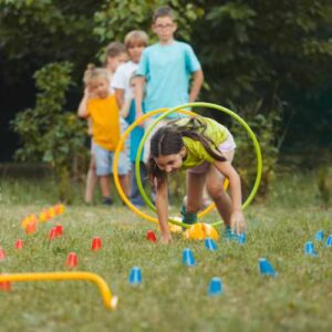 Children playing obstacle game outdoors