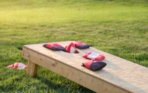 Cornhole board and bean bags in park