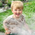 Happy toddler during water game