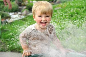 Happy toddler during water game